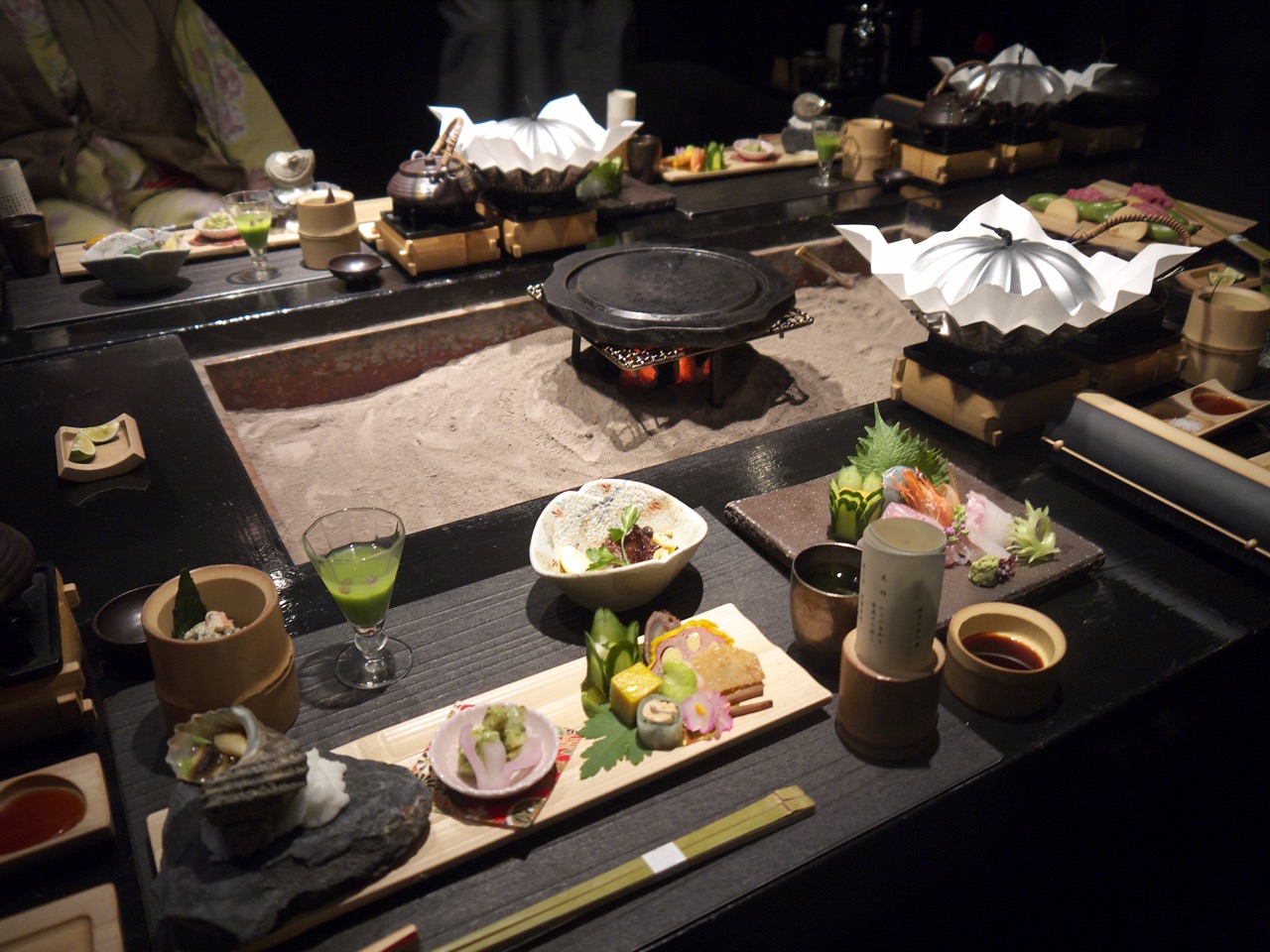 Japanese kaiseki dinner with sushi, sashimi, and hot plate cooking at a ryokan table