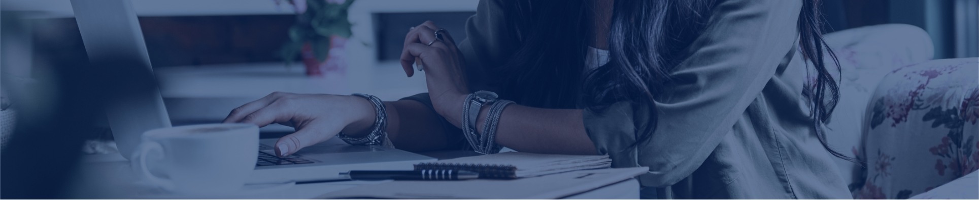 blog-hero A professional or business setting showing hands of two people working together at a desk with